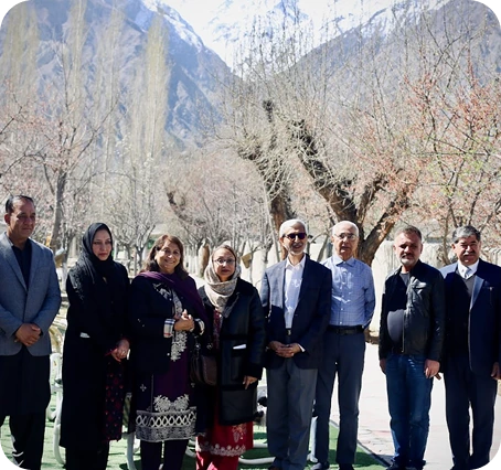 Staff standing together near the campus entrance